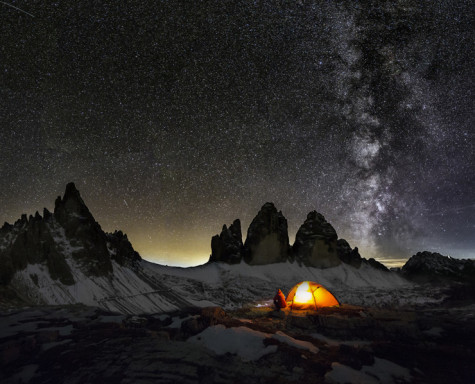 An illuminated tent in Dolomites under Milky Way  at the Cime of the Dolomites (Drei Zinnen)