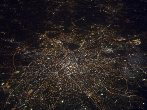 An aerial view of London at night, taken from within an aeroplane
