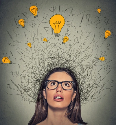 Closeup thinking woman with question signs and light idea bulb above head looking up on gray wall background