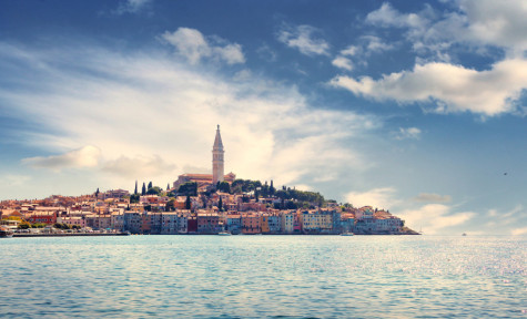 Town of Rovigno in Istria, Croatia. Taken on a bright sumer day from the sea. The church of St. Euphemia can be seen on top of the old town. Mediterranean, summertime, tourism concept.