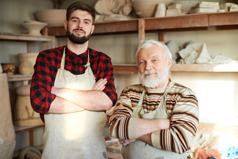 Portrait of senior man with his grandson devoted their life to pottery